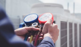 A Geothermal heating systems service technician checks to be sure there is no air in the system.